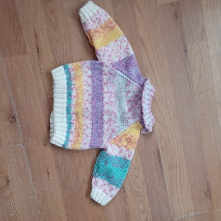 Cardigan hand knitted in soft self patterning yarn.