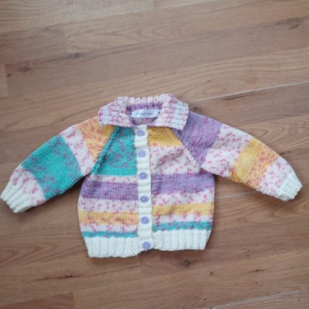 Cardigan hand knitted in soft self patterning yarn.