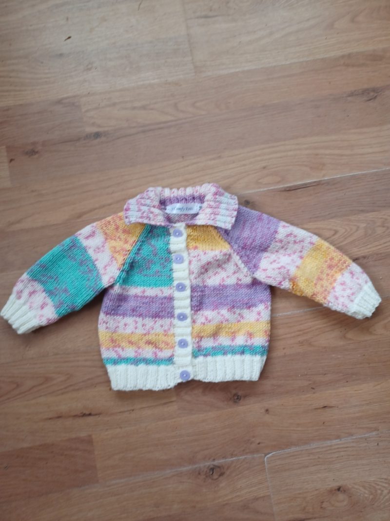 Cardigan hand knitted in soft self patterning yarn.