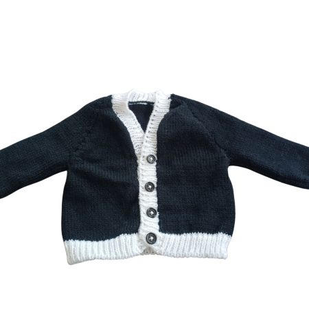 Long sleeved black cardigan with white trim. A lovely lace trim up the front and around the neck can be added. Comes is various sizes. Acrylic yarn for easy care.