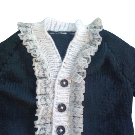 Long sleeved black cardigan with white trim. A lovely lace trim up the front and around the neck can be added. Comes is various sizes. Acrylic yarn for easy care.