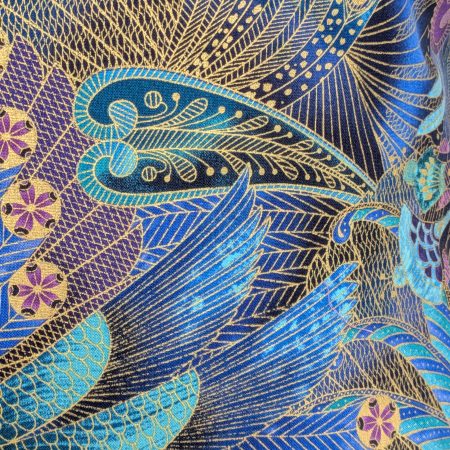 Detail of reverse of decorative cushion cover with intricate peacock feather pattern in blue, purple, and gold on black background, 18 inch, zipped and lined