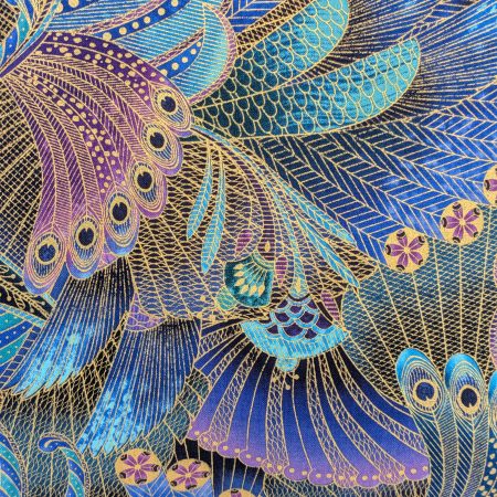 Detail of front of decorative cushion cover with intricate peacock feather pattern in blue, purple, and gold on black background, 18 inch, zipped and lined