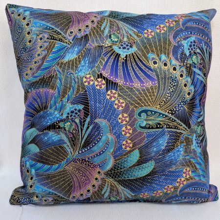 Reverse of decorative cushion cover with intricate peacock feather pattern in blue, purple, and gold on black background, 18 inch, zipped and lined