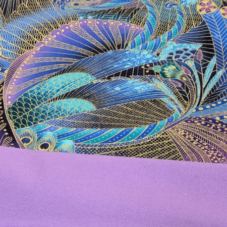 Lining detail of decorative cushion cover with intricate peacock feather pattern in blue, purple, and gold on black background, 18 inch, zipped and lined
