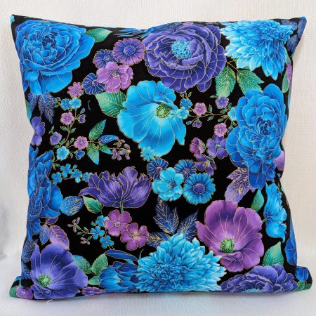 Front of decorative throw pillow cover with vibrant blue and purple floral pattern on a black background, featuring detailed blossoms and leaves.