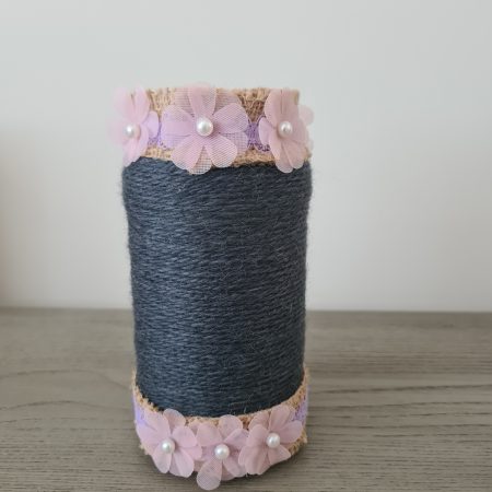 Upcycled glass jar. Wrapped with dark grey yarn and pink flowers