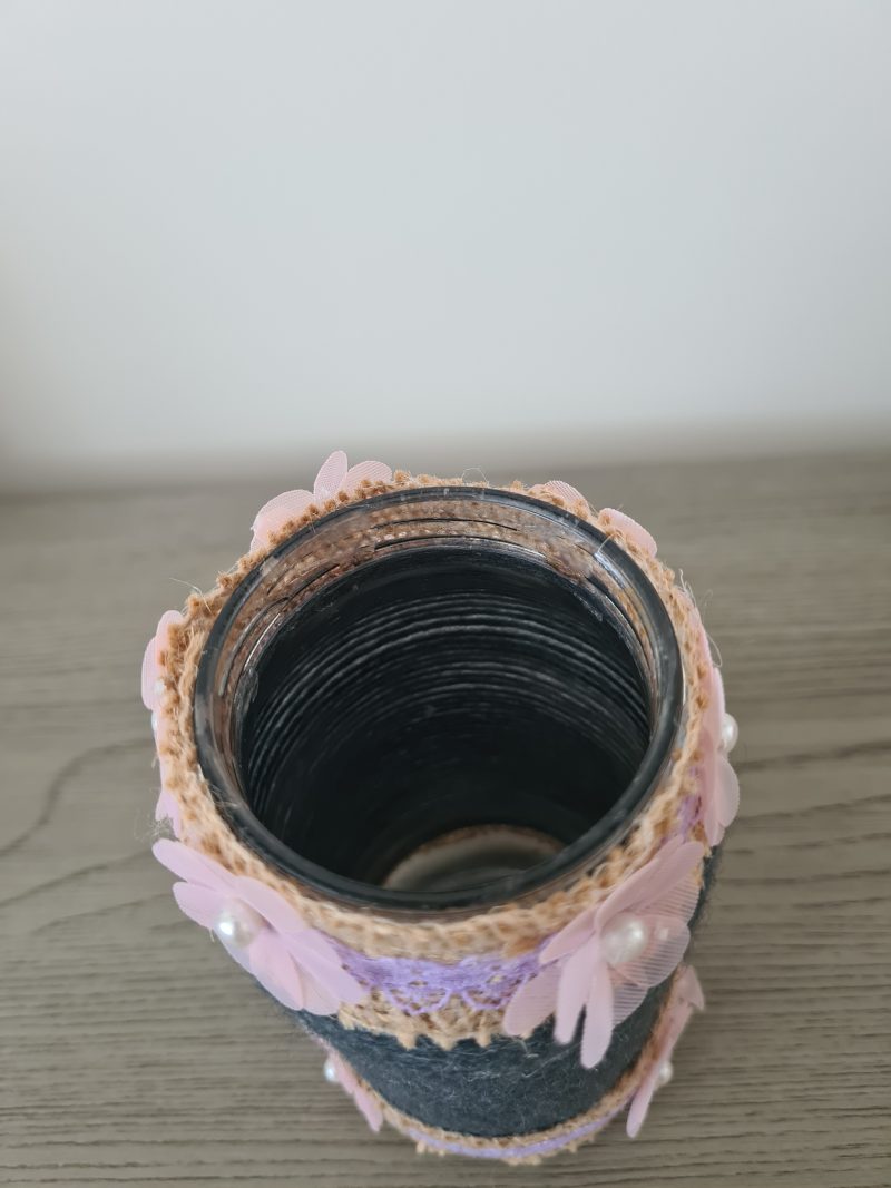 Upcycled glass jar. Wrapped with dark grey yarn and pink flowers