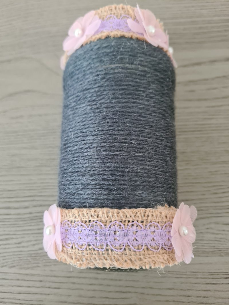 Upcycled glass jar. Wrapped with dark grey yarn and pink flowers