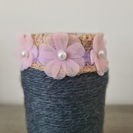 Upcycled glass jar. Wrapped with dark grey yarn and pink flowers
