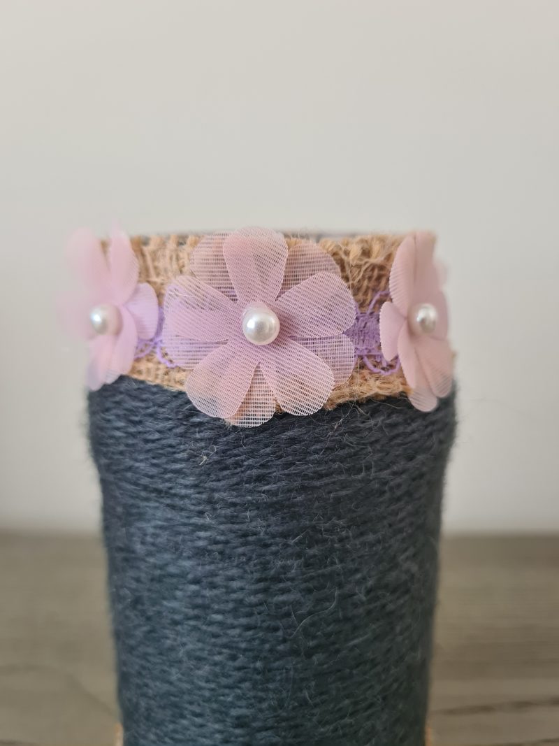 Upcycled glass jar. Wrapped with dark grey yarn and pink flowers