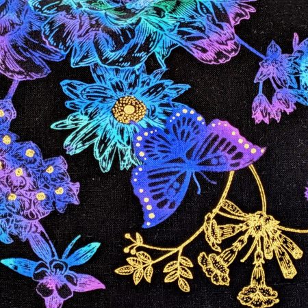 Detail of reverse of black cushion cover featuring colourful rainbow floral pattern with butterflies and gold accents, lined with a zip closure