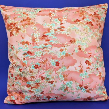 Front of pale orange cushion cover with Japanese cherry blossom design and deeper orange cloud pattern, 18 inch with zip