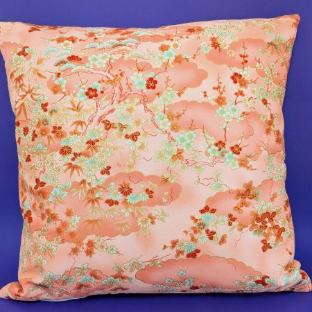 Reverse of pale orange cushion cover with Japanese cherry blossom design and deeper orange cloud pattern, 18 inch with zip