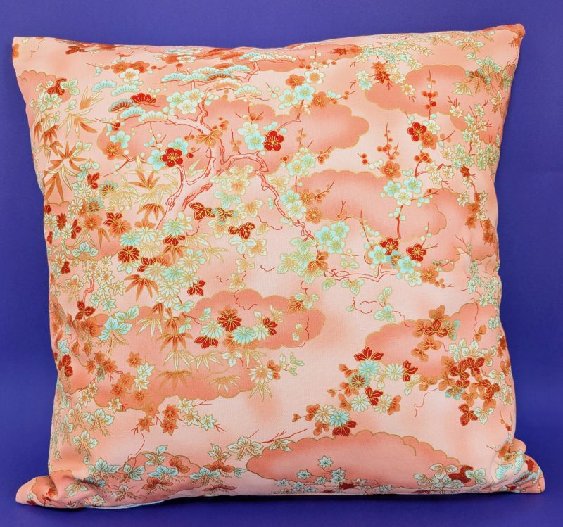 Reverse of pale orange cushion cover with Japanese cherry blossom design and deeper orange cloud pattern, 18 inch with zip