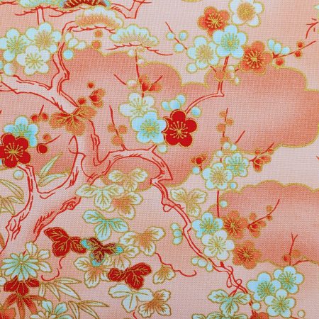 Detail of pale orange cushion cover with Japanese cherry blossom design and deeper orange cloud pattern, 18 inch with zip