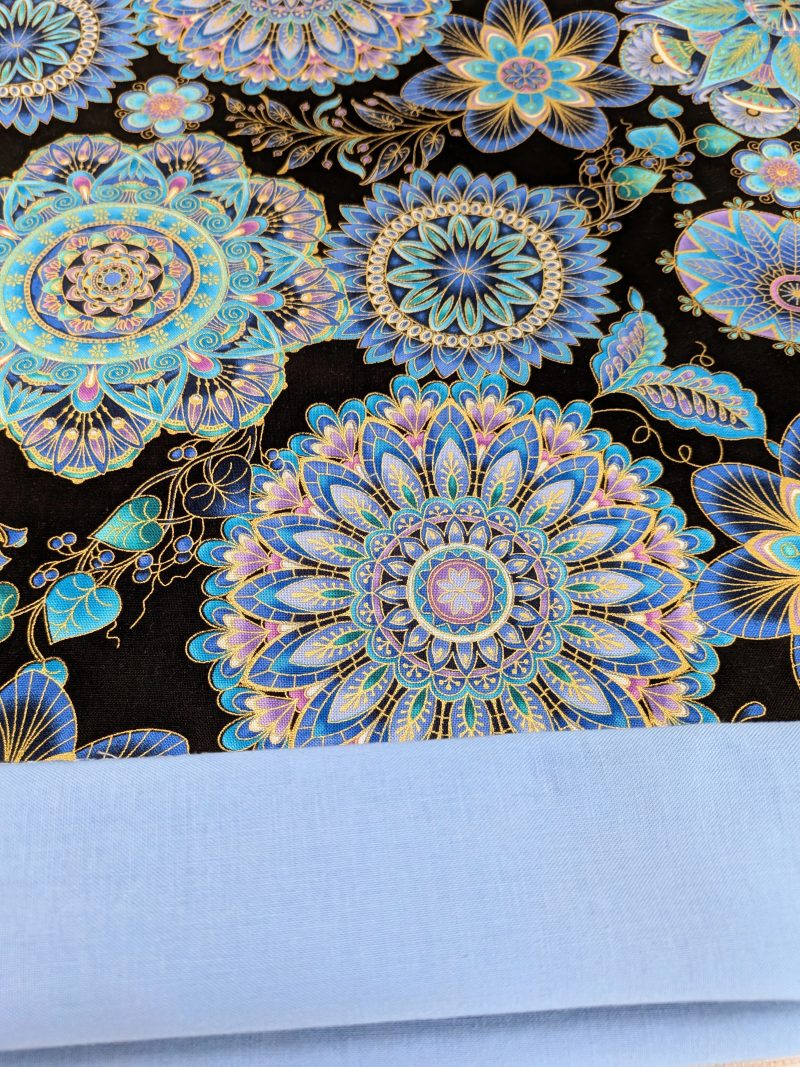 Lining detail of blue mandala floral cushion cover with intricate circular patterns on a black background, 45cm square decorative pillow case