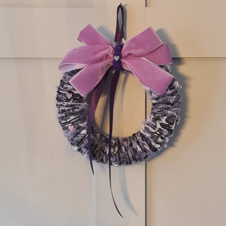 Lilac & pink yarn wrapped wreath with a velvet bow and crystal hearts