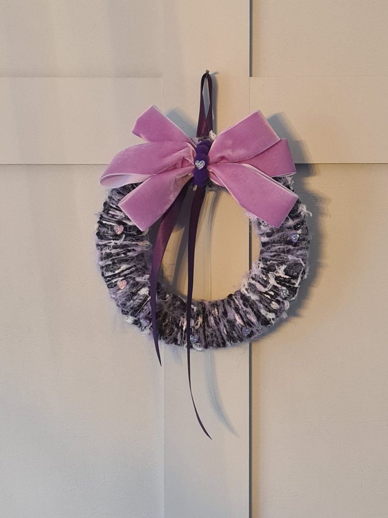 Lilac & pink yarn wrapped wreath with a velvet bow and crystal hearts
