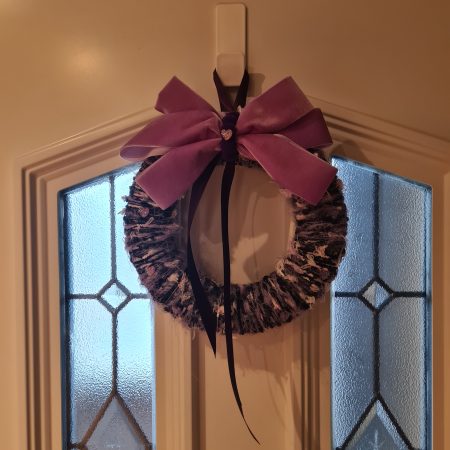Lilac & pink yarn wrapped wreath with a velvet bow and crystal hearts