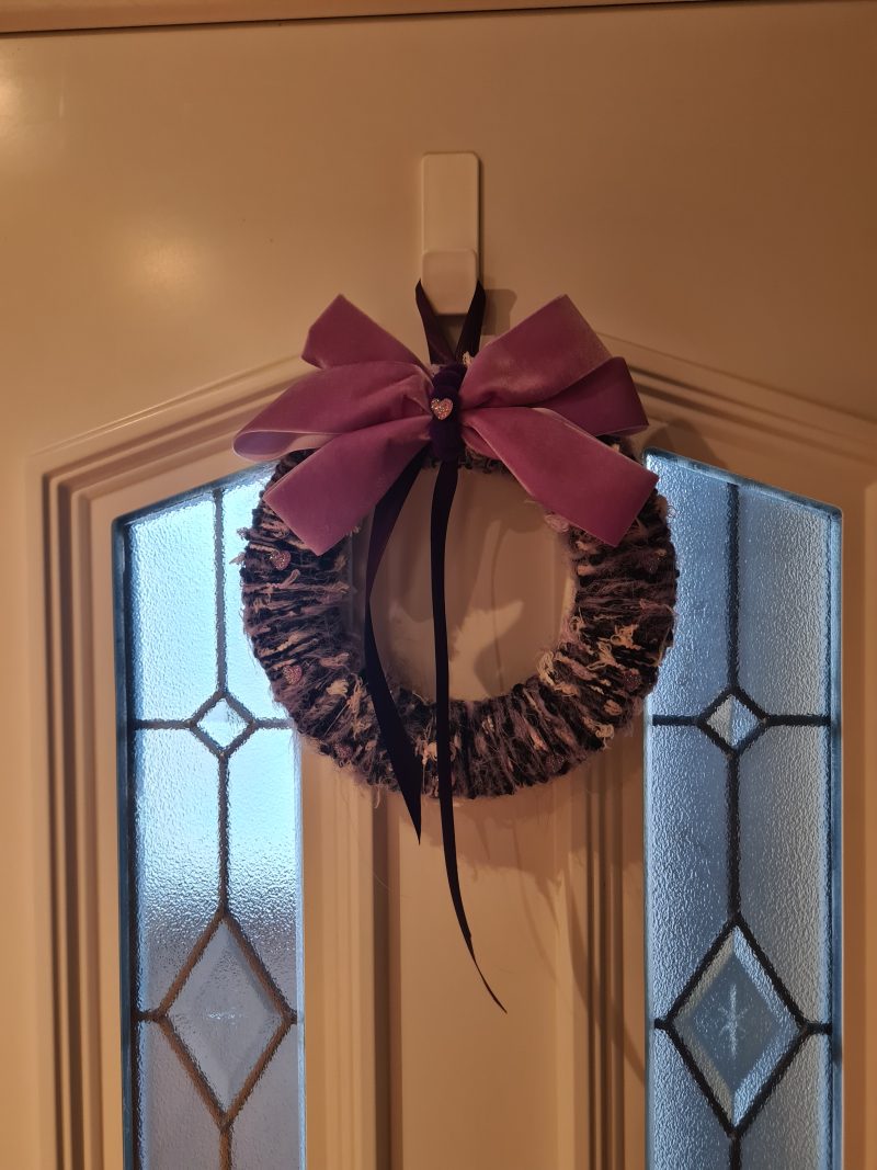 Lilac & pink yarn wrapped wreath with a velvet bow and crystal hearts