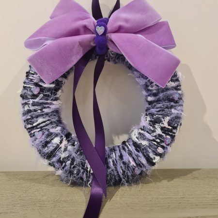 Lilac & pink yarn wrapped wreath with a velvet bow and crystal hearts