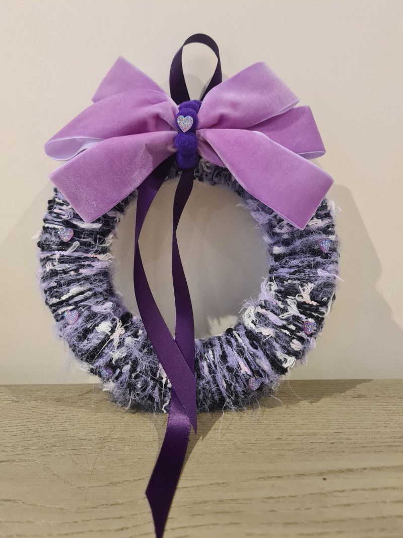 Lilac & pink yarn wrapped wreath with a velvet bow and crystal hearts
