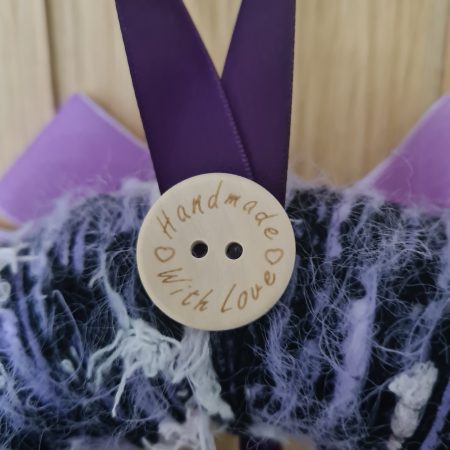 Lilac & pink yarn wrapped wreath with a velvet bow and crystal hearts