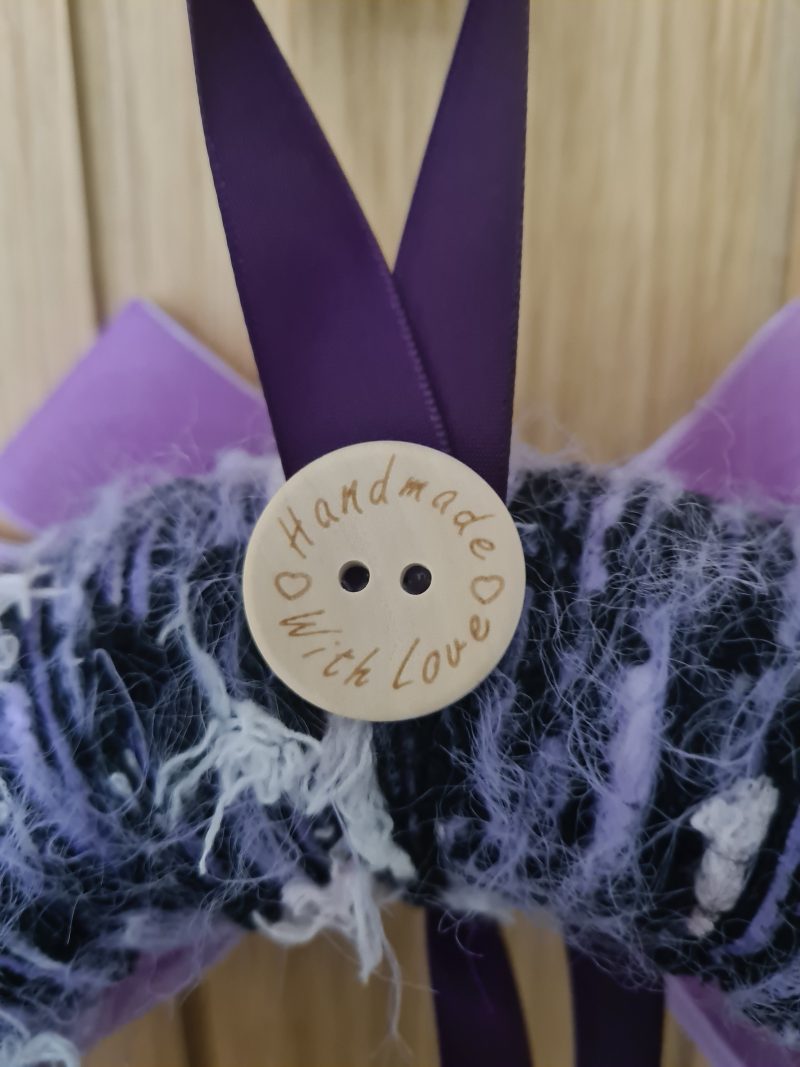 Lilac & pink yarn wrapped wreath with a velvet bow and crystal hearts