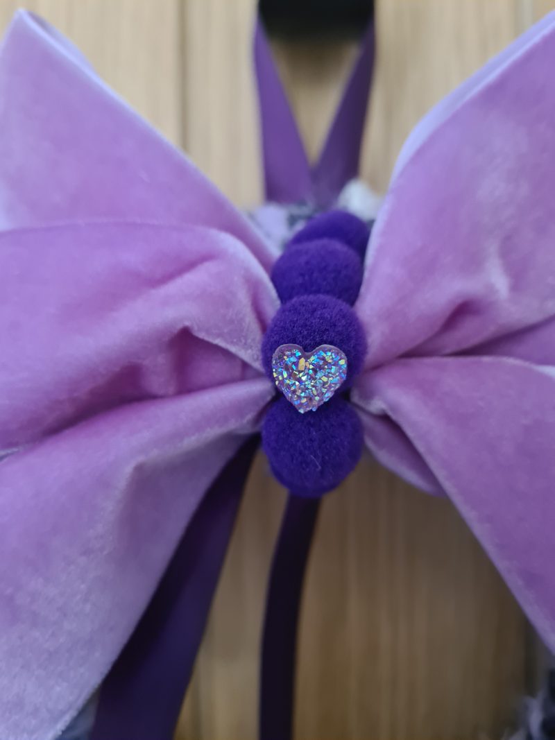 Lilac & pink yarn wrapped wreath with a velvet bow and crystal hearts