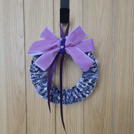 Lilac & pink yarn wrapped wreath with a velvet bow and crystal hearts
