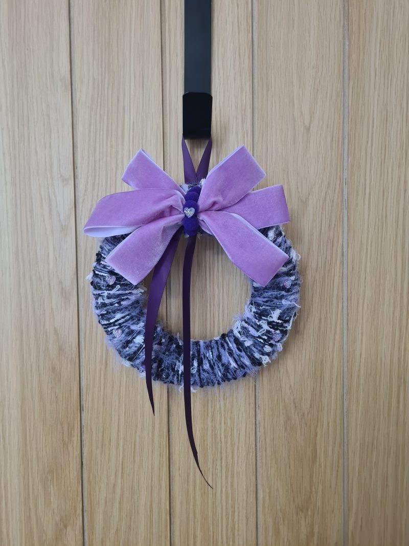 Lilac & pink yarn wrapped wreath with a velvet bow and crystal hearts
