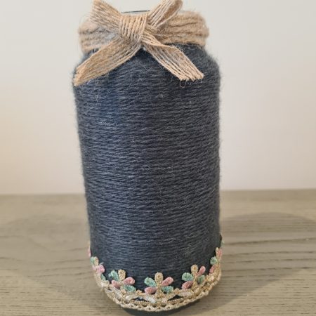 Upcycled glass jar wrapped in dark grey yarn with lace and jute trim