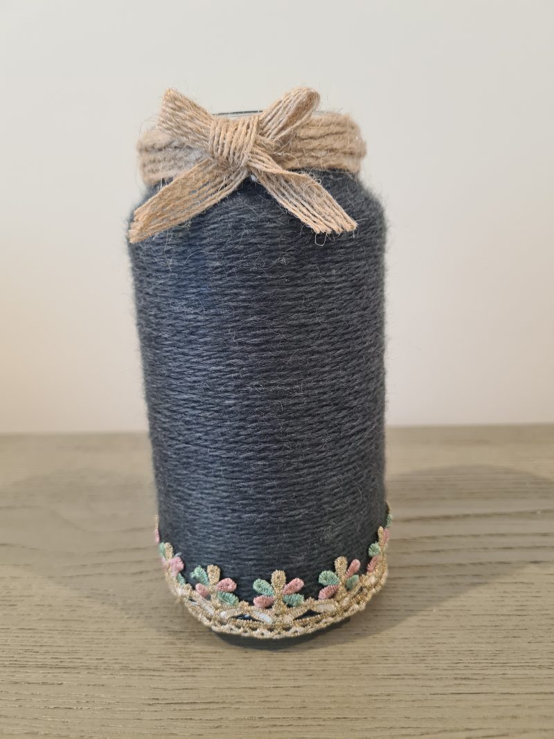 Upcycled glass jar wrapped in dark grey yarn with lace and jute trim