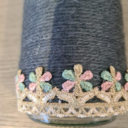 Upcycled glass jar wrapped in dark grey yarn with lace and jute trim