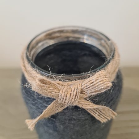 Upcycled glass jar wrapped in dark grey yarn with lace and jute trim