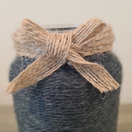 Upcycled glass jar wrapped in dark grey yarn with lace and jute trim