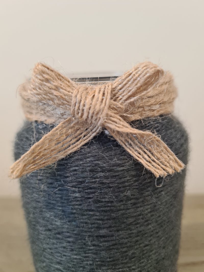 Upcycled glass jar wrapped in dark grey yarn with lace and jute trim