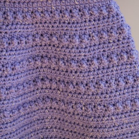 Bobble pattern on skirt part of crochet pinafore style dress