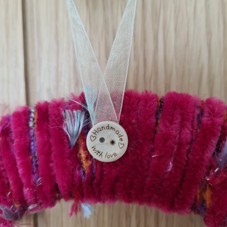 Vibrant pink yarn wrapped wreath