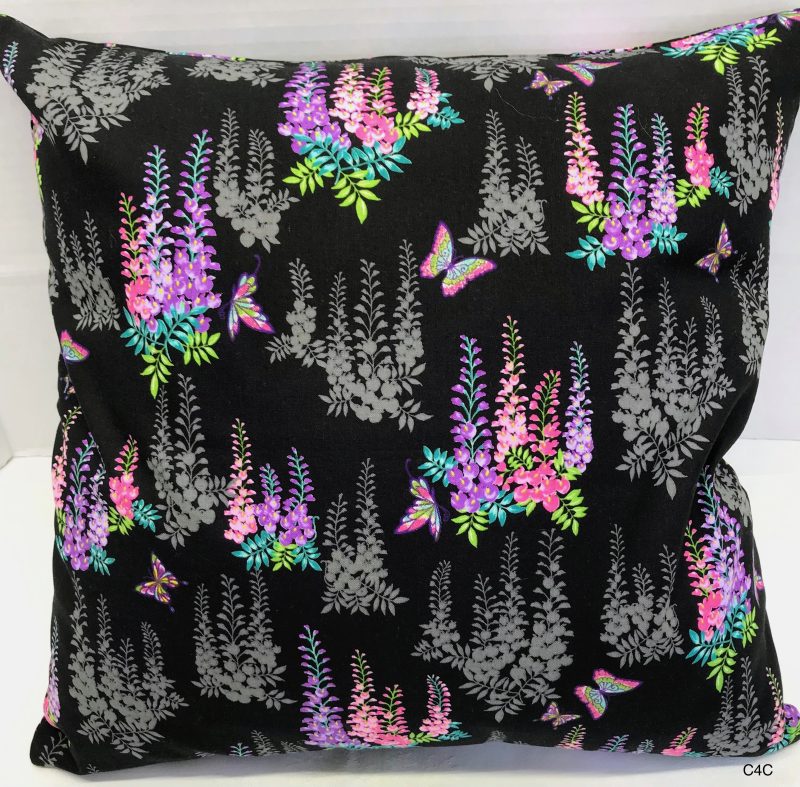 Reverse of black cushion cover with bright pink and purple floral pattern and butterflies, 18 inch square, lined with zip fastening
