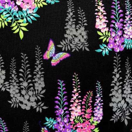 Reverse detail of black cushion cover with bright pink and purple floral pattern and butterflies, 18 inch square, lined with zip fastening