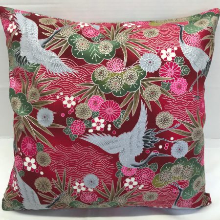 Reverse of red cushion cover with Japanese crane and floral pattern, featuring flying cranes and detailed blossoms on decorative fabric