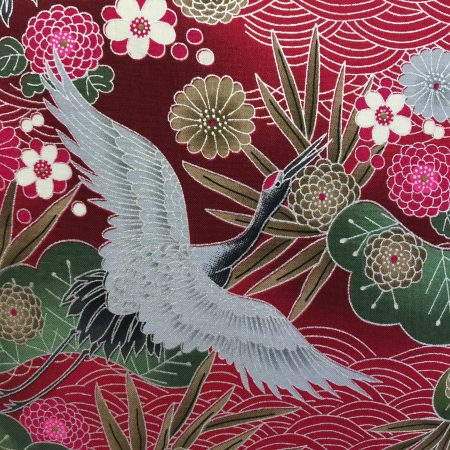 Front detail red cushion cover with Japanese crane and floral pattern, featuring flying cranes and detailed blossoms on decorative fabric