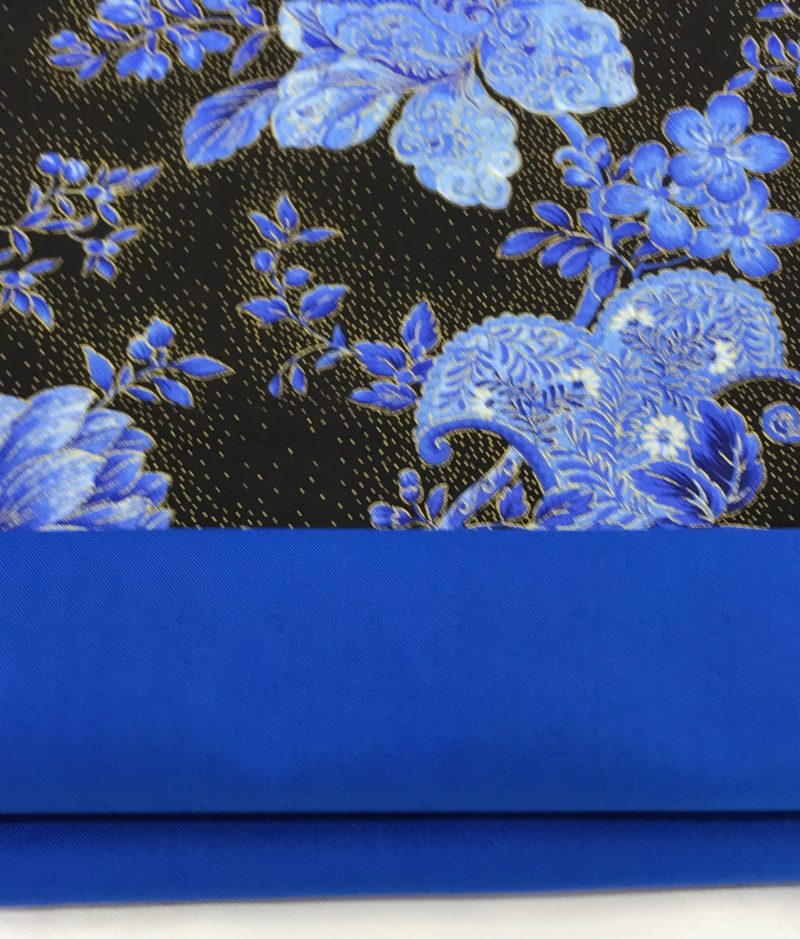 Lining detail of blue floral cushion cover with detailed flowers on a black background, 18 inch square, zipped and lined