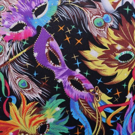 Detail of colourful cushion cover with vibrant carnival masks and feather design on a black background
