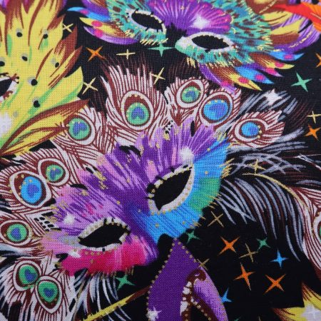 Detail of colourful cushion cover with vibrant carnival masks and feather design on a black background