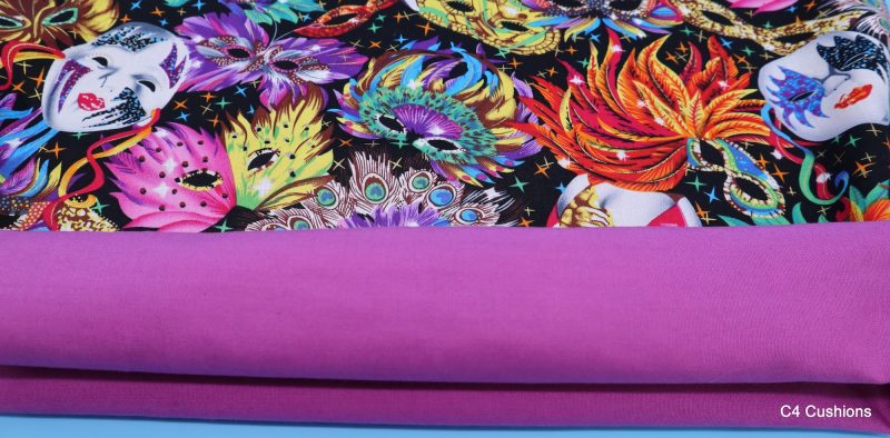 Lining detail of colourful cushion cover with vibrant carnival masks and feather design on a black background