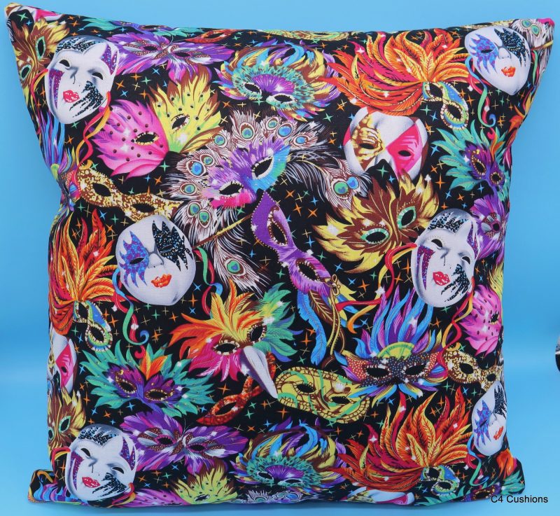 Front of colourful cushion cover with vibrant carnival masks and feather design on a black background