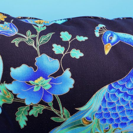 Peacock detail of blue peacock floral cushion cover with vibrant bird design on the front and feather pattern on the reverse